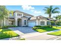 Charming two-story home with a paver driveway, attached garage, and well-maintained landscaping at 13924 Jomatt Loop, Winter Garden, FL 34787