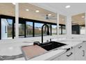 Modern kitchen sink featuring sleek countertops, a stylish faucet, and a window overlooking the pool at 1484 Lake Francis Dr, Apopka, FL 32712