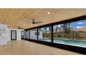 Relaxing screened-in patio with a ceiling fan and a view of the sparkling backyard swimming pool at 1484 Lake Francis Dr, Apopka, FL 32712