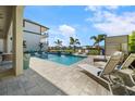 Inviting pool area with lounge chairs and lush landscaping, creating a perfect oasis for relaxation at 1526 Euston Dr, Reunion, FL 34747
