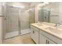 Modern bathroom with double vanity, quartz countertop, and a glass enclosed shower at 1537 Heritage Pl, Oviedo, FL 32765