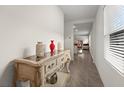 Inviting hallway featuring tile floors, neutral walls and stylish console table decorations at 1792 Bull Hill Rd, Kissimmee, FL 34744
