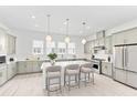 Modern kitchen with stainless steel appliances, pendant lighting, and a center island with seating at 2217 Valentine Aly, Orlando, FL 32804