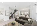 Open-concept living room with hardwood floors, modern decor, and an adjacent dining area at 2217 Valentine Aly, Orlando, FL 32804