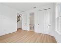 Bedroom featuring wood-look floors with an attached closet and bathroom at 2296 Brix Sts, Orlando, FL 32804