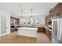 Spacious kitchen features modern appliances, a large center island, and stylish backsplash at 2296 Brix Sts, Orlando, FL 32804