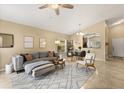 Bright living room with a stylish gray sofa, patterned rug, and adjacent dining area for comfortable living at 2422 Holly Pine Cir, Orlando, FL 32820