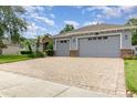 Well maintained home with a three car garage and brick paved driveway at 2588 Gabrielle Woods Pl, Oviedo, FL 32765