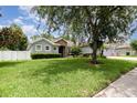 A beautifully landscaped front yard featuring a large tree and neatly trimmed hedges at 2588 Gabrielle Woods Pl, Oviedo, FL 32765