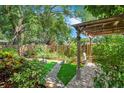 Backyard featuring a beautiful garden, walkway, and shade at 2794 Cullens Ct, Ocoee, FL 34761