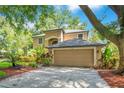 Charming home with a two-car garage and lush, tropical landscaping at 2794 Cullens Ct, Ocoee, FL 34761