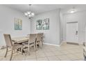 Formal dining area with elegant chandelier, neutral walls, and tile flooring at 3256 Rodrick Cir, Orlando, FL 32824