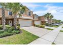 Charming townhome featuring a two-car garage, lush landscaping and curb appeal at 3256 Rodrick Cir, Orlando, FL 32824