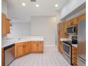 Bright kitchen with stainless steel appliances, ample cabinetry, and sleek countertops at 3713 Becontree Pl, Oviedo, FL 32765