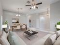 Bright open-concept living and dining area featuring contemporary furnishings and stylish decor, perfect for entertaining at 3713 Becontree Pl, Oviedo, FL 32765
