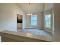 Bright dining area with a modern chandelier, neutral walls, and large windows at 3891 Sagefield Dr, Harmony, FL 34773