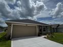 A well-maintained single Gathering house with an attached two car garage and lush green lawn at 3891 Sagefield Dr, Harmony, FL 34773