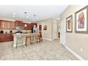 Spacious kitchen features granite counters, an island with seating, and modern stainless appliances at 4123 Oaktree Dr, Davenport, FL 33837