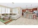 The living room seamlessly connects to the kitchen for easy entertaining at 4123 Oaktree Dr, Davenport, FL 33837