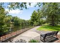 Picturesque park with benches along a scenic walkway by a calm lake, surrounded by lush greenery at 4709 Fox St, Orlando, FL 32814