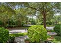 Shaded street view with green landscaping, mature trees, and a glimpse of a well-maintained neighborhood at 4709 Fox St, Orlando, FL 32814