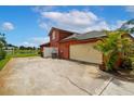 The house features an attached garage and a side yard overlooking a tranquil pond, perfect for relaxation at 5306 Crane Hill Ct, St Cloud, FL 34771
