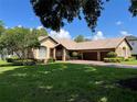 Lovely home featuring a tile roof, well-maintained lawn, mature tree, and a brick driveway with two-car garage at 5416 Bay Side Dr, Orlando, FL 32819