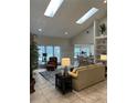 Inviting living room with skylights, vaulted ceilings, neutral colors, and seamless flow to the kitchen at 5416 Bay Side Dr, Orlando, FL 32819