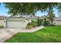 Beautiful single-story home showcasing lush green landscaping and a two-car garage at 544 Lake Sumner Dr, Groveland, FL 34736