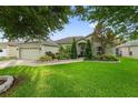 Inviting single-Gathering home with a well-maintained lawn and front garden at 544 Lake Sumner Dr, Groveland, FL 34736