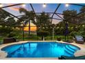 Screened-in pool with lush greenery and scenic views offering a private outdoor oasis at 544 Lake Sumner Dr, Groveland, FL 34736