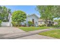 Light blue home featuring manicured landscaping and a charming front yard at 638 Clayton St, Orlando, FL 32804
