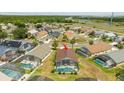 Aerial view of a neighborhood showcasing a home with a screened-in pool and beautiful surroundings at 8102 Pomo Dr, Kissimmee, FL 34747