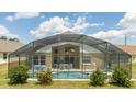 View of a beautiful screened in pool area, with a dining table and chairs for outdoor enjoyment at 8102 Pomo Dr, Kissimmee, FL 34747