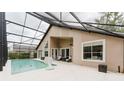 Relaxing screened-in pool with an extended deck, complemented by a comfortable seating area at 9285 Wickham Way, Orlando, FL 32836