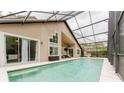 Inviting screened-in pool area with ample space for lounging and entertaining, surrounded by lush landscaping at 9285 Wickham Way, Orlando, FL 32836