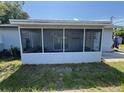 Back screened in porch with view of partially shaded backyard and concrete patio at 2315 Pembrook Dr, Orlando, FL 32810