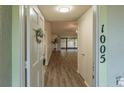 Welcoming foyer with wood-look floors leading to an open living area with backyard access at 1005 Black Willow Dr, Oviedo, FL 32765