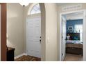 Inviting foyer with a white front door that leads into a bedroom with blue walls at 1112 Spruce Ridge Ct, Minneola, FL 34715
