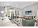 Bright living room with large windows, sleek furniture, and neutral decor at 1217 Kenwood Ave, Winter Park, FL 32789