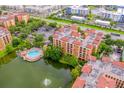 Aerial view of resort condo and community amenities, including a pool, lake and fountain at 12527 Floridays Resort Dr # E104, Orlando, FL 32821