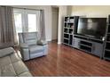 Comfortable living room showcasing a large television, modern shelving, and a plush reclining armchair at 13000 Sandy Pine Ln, Clermont, FL 34711