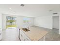 Bright, open-concept kitchen featuring granite countertops and views of the backyard at 1349 Oak Valley Dr, Auburndale, FL 33823