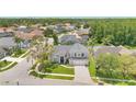 Aerial view of a charming neighborhood showcasing a home with a well-kept lawn and three-car garage at 13691 Crystal River Dr, Orlando, FL 32828
