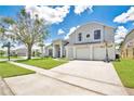 Attractive home with three-car garage, well-maintained lawn, and decorative windows at 13691 Crystal River Dr, Orlando, FL 32828