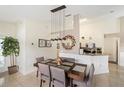 Bright dining room with stylish chandelier, modern decor, and easy access to the kitchen at 150 Barefoot Beach Way, Kissimmee, FL 34746