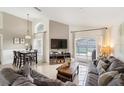 Inviting living room with comfortable sofas and sliding glass doors leading to the pool area at 150 Barefoot Beach Way, Kissimmee, FL 34746