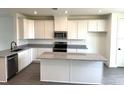 Modern kitchen featuring white cabinets, granite countertops, stainless steel appliances, and center island at 15119 Grove Lake Dr, Winter Garden, FL 34787
