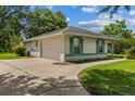 Exterior view of a single-Gathering home, showcasing an attached garage and well-manicured lawn at 19 Hemlock Terrace Way, Ocala, FL 34472