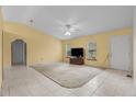Bright living room with tile floors, a ceiling fan, and natural light through the windows at 19 Hemlock Terrace Way, Ocala, FL 34472